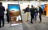 Vertical touch screen displaying the Borely platform on the conference floor with attendees in background